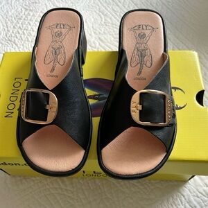 Fly London Black Leather Mules with Gold Buckle NIB